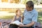 Asian elderly having faith to the Lord, God reading bible outdoor with kid