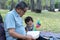 Asian elderly having faith to the Lord, God reading bible outdoor with kid