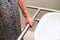 Asian elderly old woman patient use toilet support rail in bathroom, handrail safety grab bar, security in nursing hospital