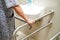 Asian elderly old woman patient use toilet support rail in bathroom, handrail safety grab bar, security in nursing hospital