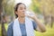 Asian elderly or senior woman drinking water in bottle after exercise for refreshing.