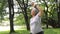 Asian elderly woman exercising in the park She smiled happily.