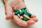 Asian elderly woman holding pill drug in hand, strong healthy medical concept