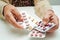 Asian elderly woman holding pill drug in hand, strong healthy medical concept