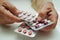 Asian elderly woman holding pill drug in hand, strong healthy medical concept