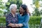 Asian elderly woman hug with her daughter with love, care, help, encourage and empathy at park, healthy strong medical concept