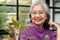 Asian elderly woman living at home She smiled happily planting trees