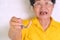 Asian Elderly woman over 70 years old holding dentures in hand. Dentures for prosthetic devices constructed to replace missing tee