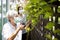 Asian elderly woman is pruning branches in the garden at home,senior mother and daughter are doing tree planting activities during