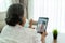 Asian elderly woman virtual happy hour meeting and talking online together with her daughter in video conference with tablet for a