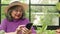 Asian elderly women live at home. She holds a smartphone to chat online with her friends.
