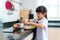 Asian elementary school student girl in uniform making sandwich for lunch box in morning school routine for day in life getting