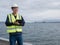 An asian engineer holding a clip board and standing