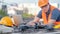 Asian engineer man using drone and laptop for construction site