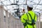 Asian engineer technician watching construction control in the construction of roof structures on construction site an Unfinished