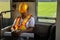 Asian engineer wearing safety helmet tired fall asleep during working hours in train