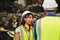 Asian engineer worker working women working together with young male man at heavy industry workplace waring helmet safety suit