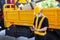 Asian engineering workers with safety equipment standing in front of trucks use tablet to communicate with trucks at construction