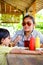 Asian Ethnicity Boy Being Feed Lunch Meals Pasta by His Mother in A Restaurant