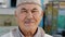 Asian face portrait of senior man smiling or old person farmer on outdoor apiary