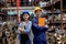Asian factory man and warehouse worker woman with smiling hold clipboard or tablet and stand together also look to camera stay in