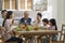 Asian family chatting while eating meal