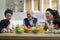 Asian family chatting while eating meal