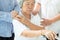 Asian family consoling depressed senior woman;sad elderly people with depressive symptoms need close care;hands on the shoulder;