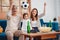 Asian Family with daughter watching sport football cheering excited