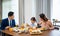 Asian family eating healthy breakfast food on dining table kitchen in mornings together at home