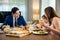 Asian family eating healthy breakfast food on dining table kitchen in mornings together at home