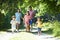 Asian Family Enjoying Walk In Countryside