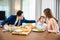 Asian family father, mother with children daughter eating breakfast food on dining table kitchen in mornings