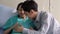 Asian family husband listening sound flex in pregnant woman belly. Children flex in the stomach at hospital on the bed. Concept of