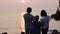 Asian family looking sunset with sea background