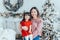 Asian family mother holding daughter toddler girl celebrating Christmas or New Year. Mixed race mom with kid child standing by