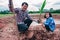 Asian family plating tree for organic farm in rural on sky background