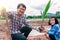 Asian family plating tree for organic farm in rural on sky background