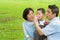 Asian family playing bubble wand