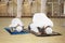 Asian family praying in the mosque