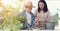 Asian family prepare black soil to little plant on in the garden