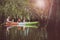 asian family sailing fresh water kayak in mangrove lagoon,kayaking is one of most popular activity in young people lifestyle