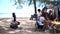 Asian family with senior and kids relaxing and camping on tropical beach during summer holiday. Togetherness and outdoor activity