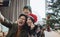 Asian family taking selfie near Christmas tree together at home. Family, holidays, Christmas concept