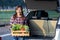 Asian farmer is delivering freshly harvest of organics vegetable box into the customer trunk car for supporting local business