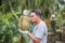 Asian farmer holding Durian is a king of fruit