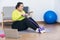 Asian fat woman, attractive and young exercising at home with the use of assistive devices tighten the muscles