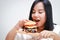 Asian fat woman eats a large hamburger
