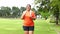 Asian fat woman smiling happy running outdoor exercise to lose weight