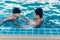 Asian father and baby lessons swimming pool in water